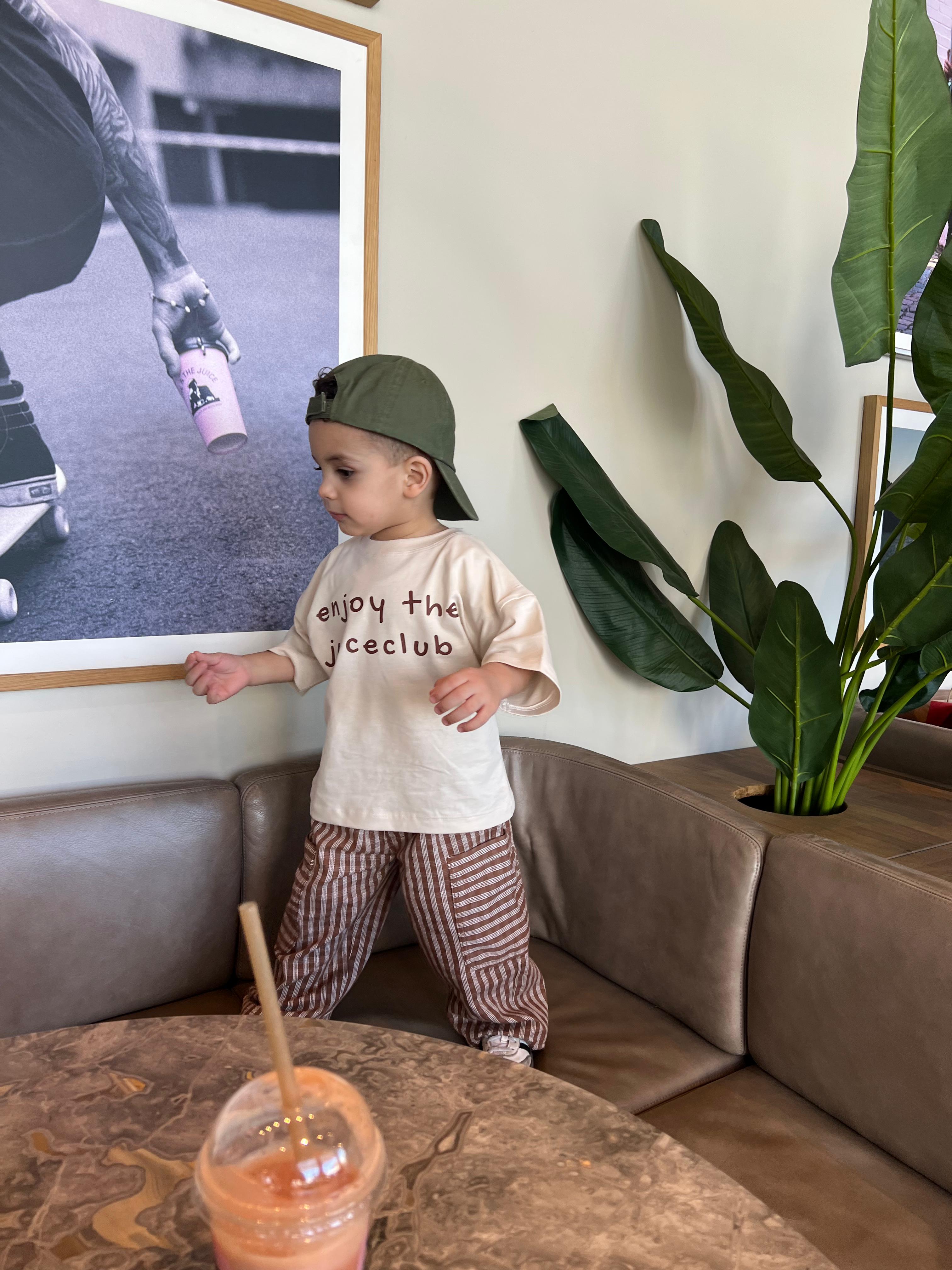 Toddler styling Boo and Coo mocha check cargo pants indoors