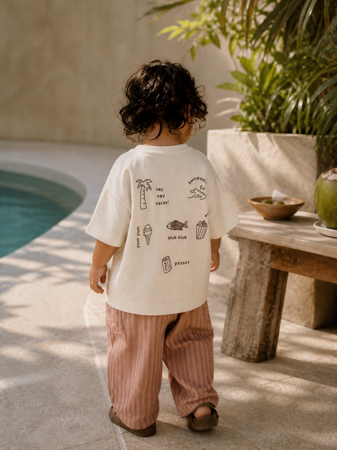 Toddler wearing Boo and Coo blush stripe wide leg pants in a relaxed summer outfit