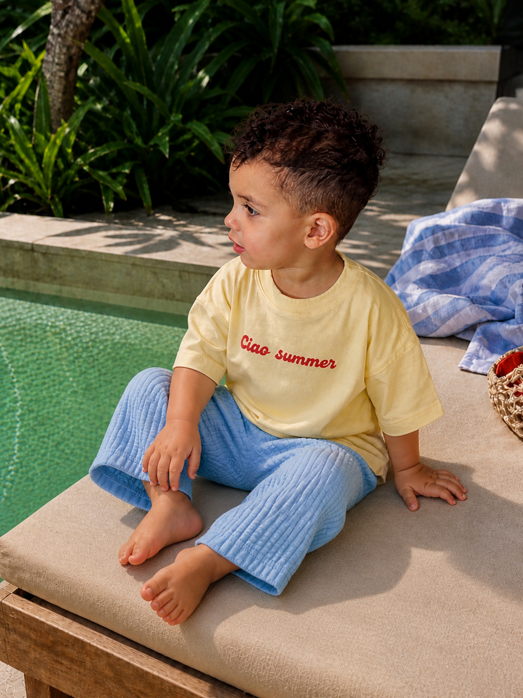 Side view of toddler wearing Boo and Coo Ciao Summer oversized tee