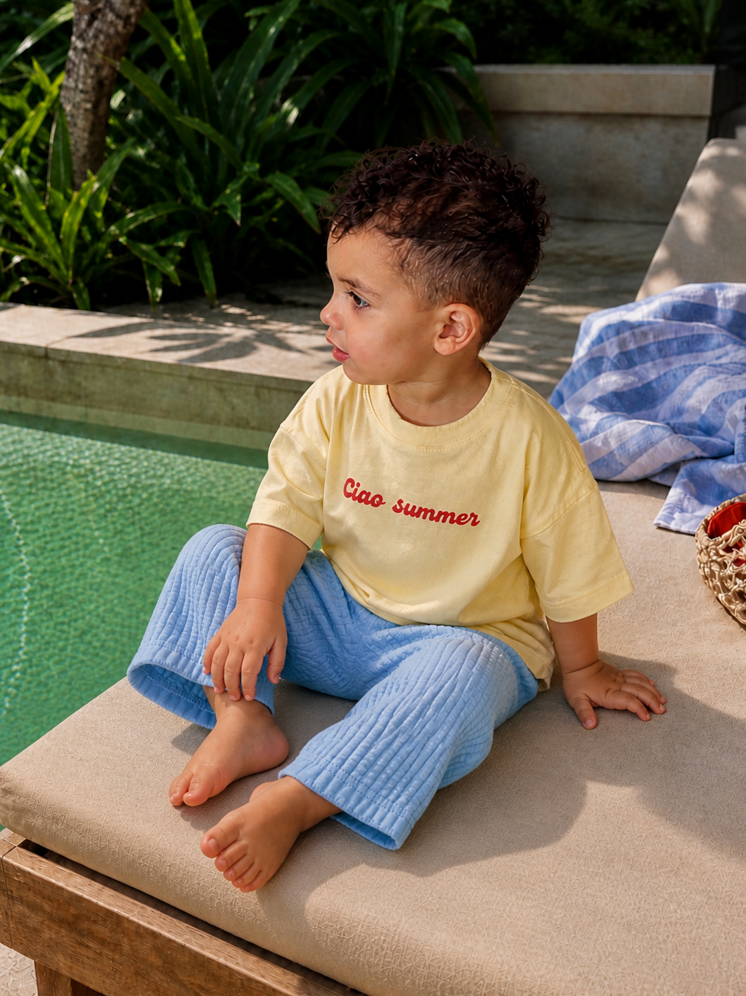 Side view of toddler wearing Boo and Coo Ciao Summer oversized tee