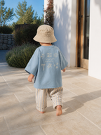 Toddler wearing Boo and Coo Salt Air Baby oversized t-shirt in a summer outfit